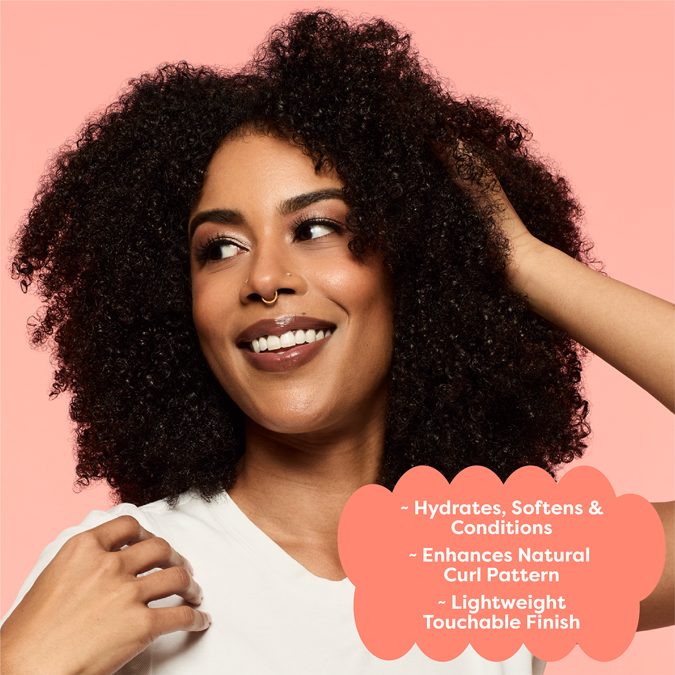 Woman with curly hair smiling against a pink background with product benefits text.